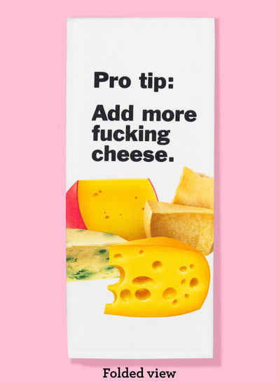 Folded dishtowel with the phrase pro tip: add more fucking cheese. The illustration is of various wedges of cheese, including parmesan and swiss cheese