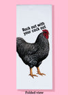 Folded dishtowel with the phrase rock out with your cock out. The illustration is of a rooster with black and white feathers