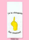 Folded view of the A la chingada los trastes dishtowel. This dishtowel features a rubber glove, middle finger, and soap bubbles as well as the humorous phrase.