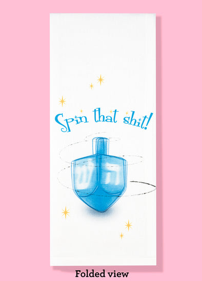 Folded dishtowel with illustration of a spinning dreidel and the phrase Spin that Shit.