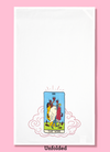 Unfolded dishtowel of an illustration of a faux tarot card featuring women dancing and holding glasses of wine with the phrase The Wine