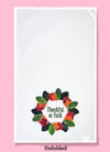 Unfolded dishtowel with the phrase thankful as fuck. The text is surrounded by a circle of illustrations of autumn leaves