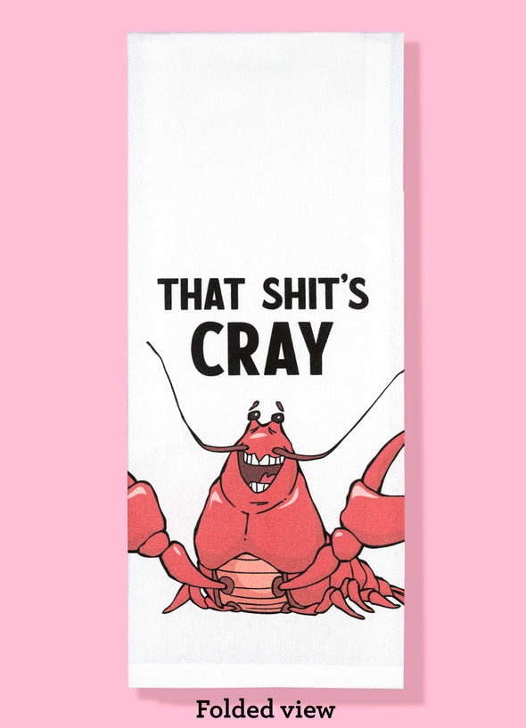 Folded dishtowel with the phrase that shit's cray. The illustration is of a cartoon crayfish smiling