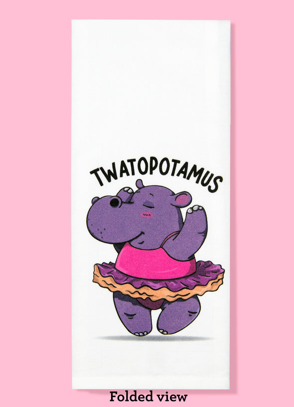 Folded dishtowel with the phrase twatopotamus. The illustration features a cartoon hippopotamus dancing while wearing a tutu