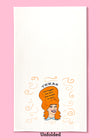 Unfolded dishtowel with the phrase Texas the bigger the hair, the closer to God. The illustration is of a cartoon smiling woman with large red hair.