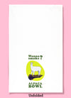 Unfolded dishtowel with the humorous phrase Wanna smoke? alpaca bowl. The text is in a cartoon illustration of a minature alpaca standing on top of a marijuana pipe.