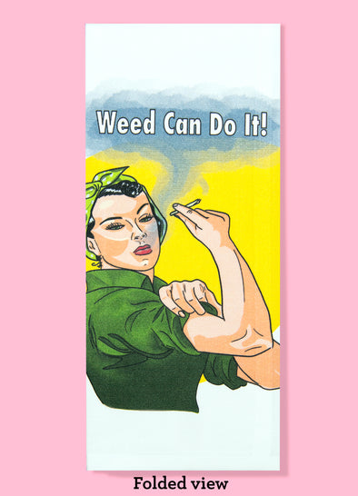 Folded dishtowel with the phrase weed can do it. The illustration features an imitation of Rosie the Riveter holding a marijuana cigarette blowing out smoke. The background is yellow.